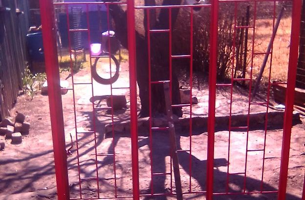 zink and window frame with burgaler bars
