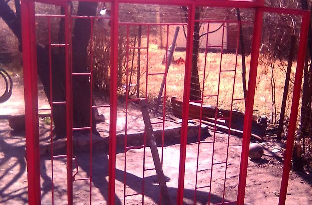 zink and window frame with burgaler bars